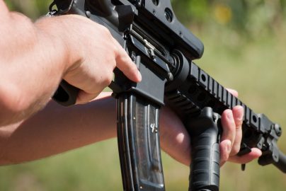 A man target shooting at a gun range