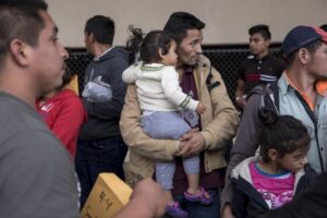 migrant-men-kids-bostonglobe-com