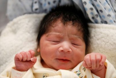 The Wider Image: New mother on migrant caravan hopes Trump's heart softens