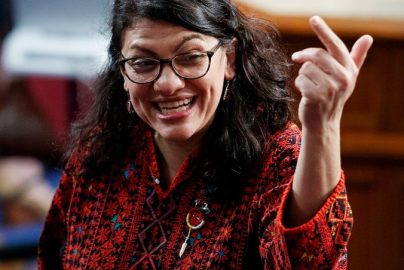 In this Thursday, Jan. 3, 2019 photo, then Rep.-elect Rashida Tlaib of Michigan, is shown on the house floor before being sworn into the 116th Congress at the U.S. Capitol in Washington. Tlaib exclaimed at an event late Thursday that Democrats were going to “impeach the mother------.” According to video and comments on Twitter, she apparently made the comments during a party hosted by the liberal activist group MoveOn. (AP Photo/Carolyn Kaster)