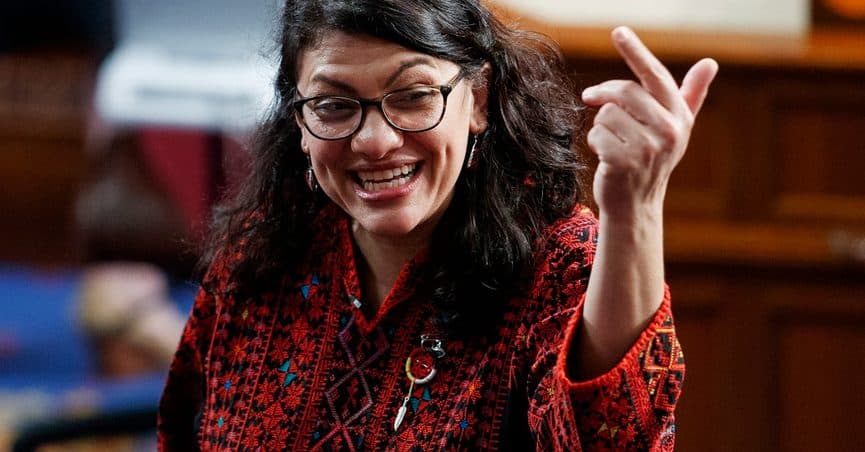 In this Thursday, Jan. 3, 2019 photo, then Rep.-elect Rashida Tlaib of Michigan, is shown on the house floor before being sworn into the 116th Congress at the U.S. Capitol in Washington.  Tlaib exclaimed at an event late Thursday that Democrats were going to “impeach the mother------.” According to video and comments on Twitter, she apparently made the comments during a party hosted by the liberal activist group MoveOn.  (AP Photo/Carolyn Kaster)