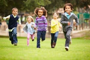 42308258 - group of young children running towards camera in park