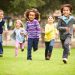 42308258 - group of young children running towards camera in park