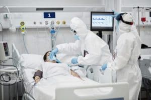 Doctors Adjusting Oxygen Mask of Patient During COVID-19