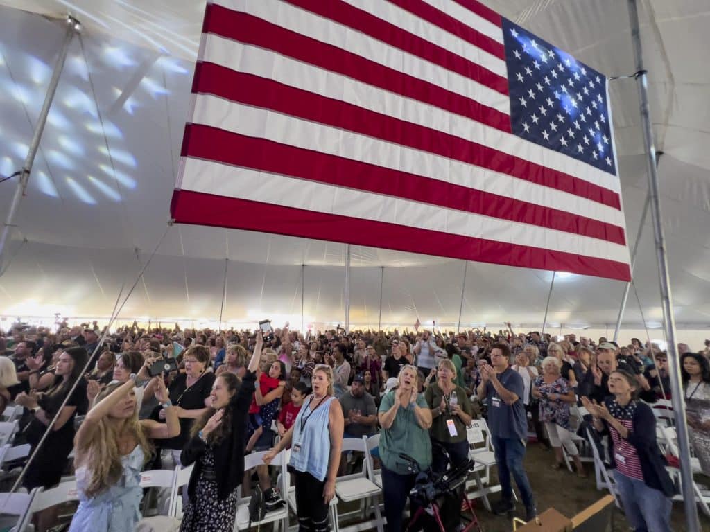 reawaken-america-tour-attendance-audience-large-usa-american-flag-apnews-com-2023-truth