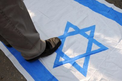 zionism-stepping-on-israel-flag-nytimes-com-2024-truth