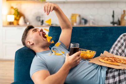 man-junk-food-eating-before-bed-laying-down-trendradars-com-2025-truth